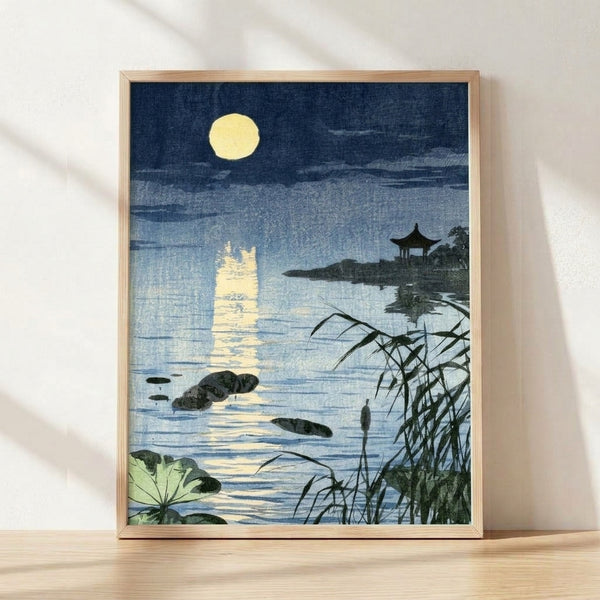 Serene Japanese woodblock print featuring a moonlit pagoda pavilion reflected in still water, rendered in navy blue, cream, and soft green tones with minimalist aesthetic.