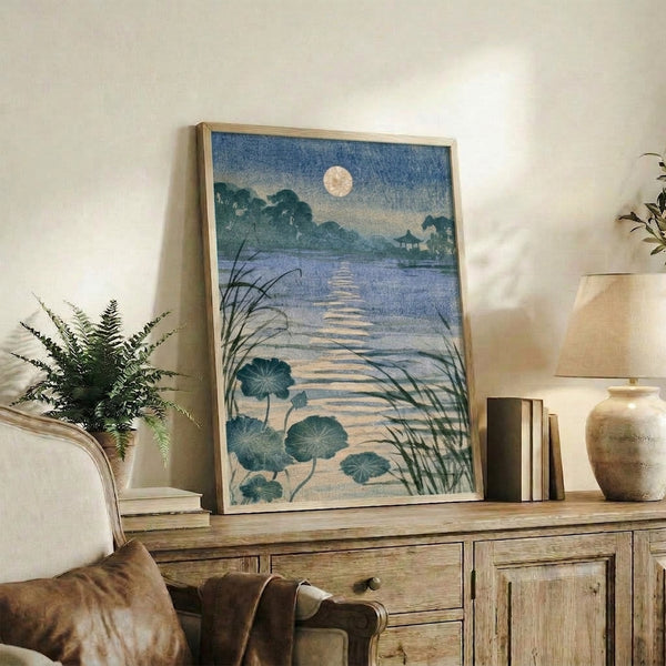 Minimalist Japandi art print showing a tranquil garden scene with moon, lotus flowers, and water in soft grey and dark teal hues, displayed as a framed poster.
