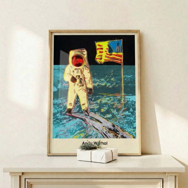 Framed poster featuring a spacesuit-clad figure on the moon rendered in graphic pop art style using monochromatic grays and silver tones for a statement wall.