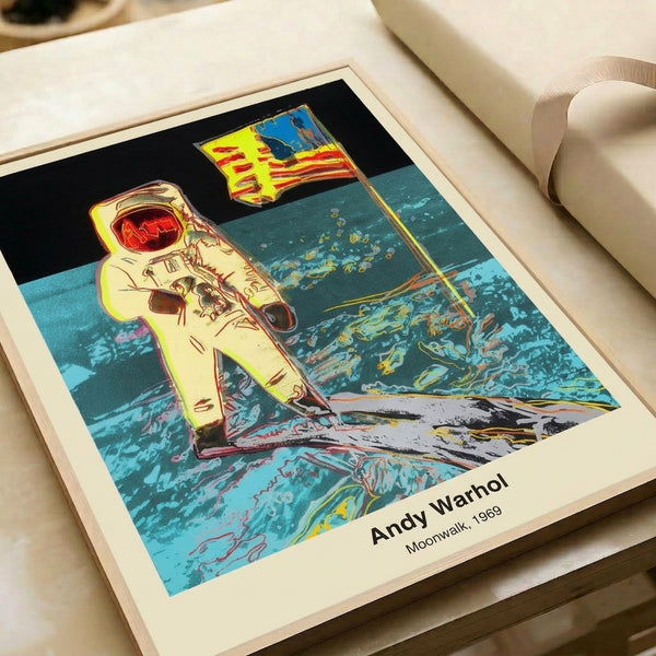 Framed pop art print showcasing the moonwalk in bold grayscale and silver tones, capturing the monumental space exploration achievement with striking graphic style.