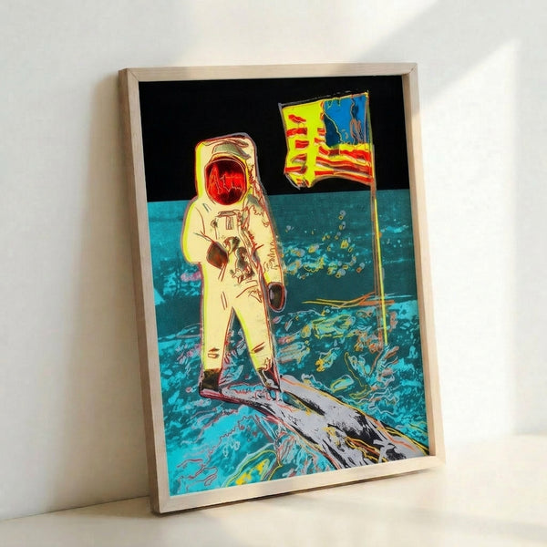 Contemporary pop art print showing an astronaut on the moon in striking jewel tones and bold outlines, displayed as a framed wall poster.