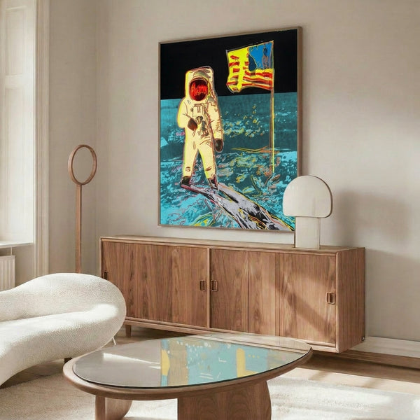 Framed pop art poster featuring a spacesuit-clad figure on the moon, created in bold contemporary graphic style with vibrant color palette.