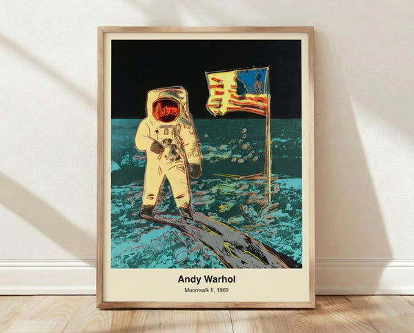 Framed pop art poster of an astronaut in a spacesuit on the moon, rendered in bold black, silver, and white tones in the style of Andy Warhol's iconic 1969 Moonwalk II artwork.