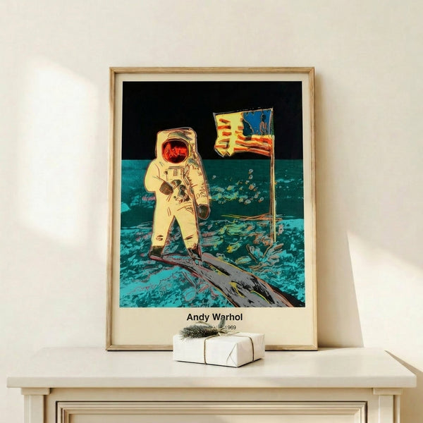 Framed contemporary pop art print showing an astronaut moonwalking in silver, black, and white tones, capturing the historic significance of space exploration through Warhol's modern artistic lens.