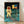 Moonwalk II pop art poster in vibrant colors framed on a wall, featuring bold graphic interpretation of the historic moon landing.