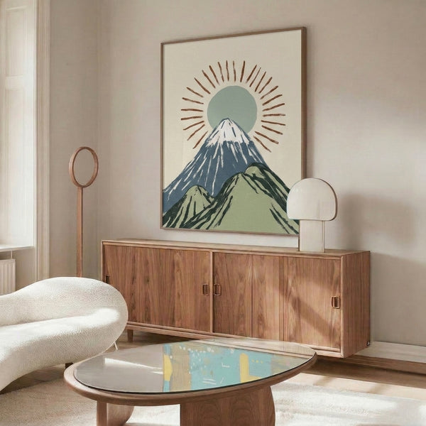 Wall-mounted framed print of a Japanese mountain sunrise scene featuring Mount Fuji, wabi sabi design sensibility, and soft contemplative tones of green, blue, cream, and brown.