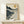 Serene mountain valley artwork with piano keyboard texture, golden sun, and muted teal and gray tones in a contemplative japandi aesthetic.