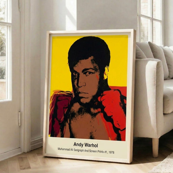 Contemporary pop art portrait of Muhammad Ali displayed as a framed wall print, featuring bold color separation and graphic intensity in vibrant reds, yellows, and blues.