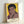 Pop art interpretation of Muhammad Ali's face rendered in bold black outlines with luminous yellow and red accents, presented as a contemporary wall art poster.