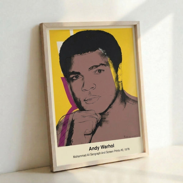 Pop art interpretation of Muhammad Ali's face rendered in bold black outlines with luminous yellow and red accents, presented as a contemporary wall art poster.