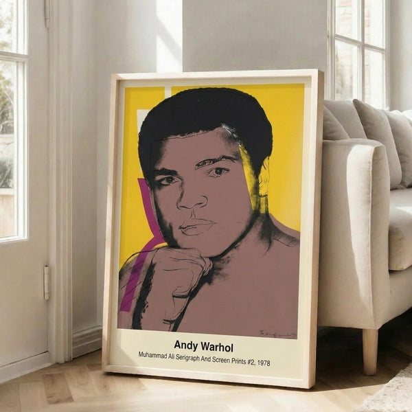 Vibrant pop art portrait serigraph showcasing Muhammad Ali in high-contrast yellow, red, and black hues on white, framed as a modern decorative print.