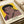 Muhammad Ali pop art poster in Warhol's distinctive technique, showcasing the legendary boxer's bold visage in striking yellow, red, and black hues framed on a wall.