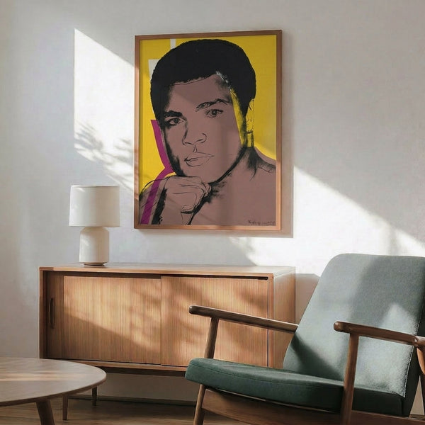 Vibrant Muhammad Ali pop art print on gallery wall, rendered in bright, saturated tones with the distinctive silkscreen aesthetic of contemporary portrait art.