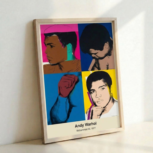 Modern pop art poster of boxer Muhammad Ali with powerful raised fists, using high-contrast black and white with vivid accent colors characteristic of Warhol's technique.