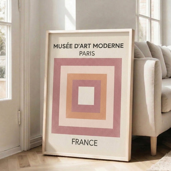 Minimalist wall art with intersecting geometric shapes in warm pastels and black, embodying modernist design principles.