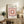 Abstract geometric print in soft mauve and peach tones with overlapping squares, displayed as a framed decorative poster.