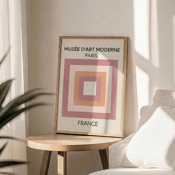 Bauhaus-inspired composition of interlocking rectangles in cream, dusty pink, and black on a gallery wall.