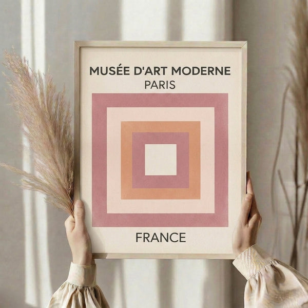 Serene minimalist poster featuring layered geometric squares in peachy mauve and cream, framed as contemporary wall decor.