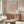 Abstract geometric artwork featuring interlocking rectangles in peach, mauve, and black, embodying serene modernist style.
