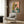 Creative line art poster showcasing a musical still life arrangement of a saxophone, lily flowers, and retro headphones in a playful composition with coral, teal, and green palette.