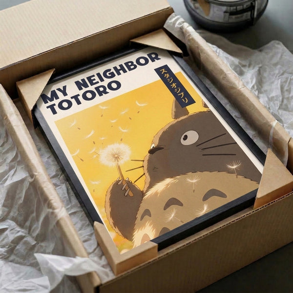 Japanese anime print of Totoro holding a dandelion in a serene moment, featuring the signature Ghibli style with a palette of golden yellows, warm browns, cream, and cool navy tones.
