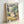 Japandi wall art depicting Totoro in a spring meadow with delicate flowers and soft pastel colors including cream, sage, and blush pink, evoking a tranquil, enchanting feeling.