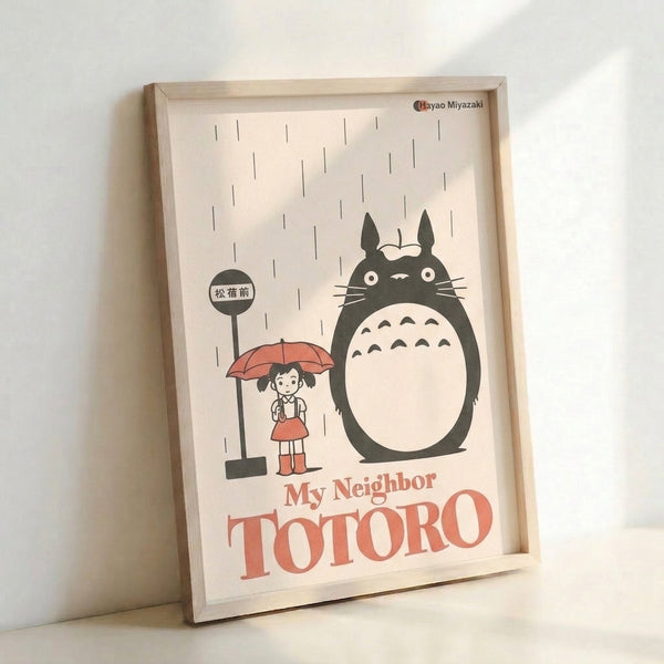Studio Ghibli-inspired poster showing Totoro and umbrella-holding child at a bus stop in gentle rain, combining minimalist linework with warm cream, charcoal, and coral red color scheme.