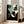 Edgy minimalist art print in retro Bauhaus style showing a stylized woman's features with black outlines and bold teal and cream tones.