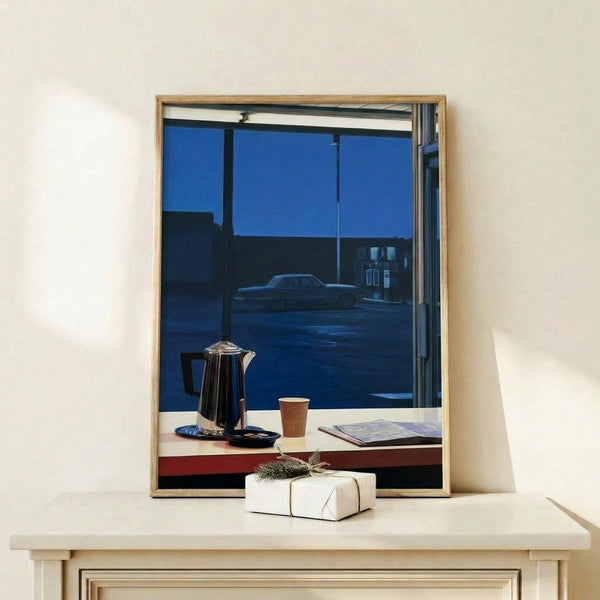 Modern retro-style framed poster showing a solitary diner scene with coffee pot under night sky, dominated by deep blues and blacks with rust-red accents creating quiet melancholy atmosphere.
