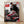 Retro modern poster featuring a classic Air Max 1 sneaker in red, white, and black against an urban landscape, framed on a wall.