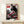 Aspirational retro poster depicting a white and red Air Max 1 with city silhouettes in black and gray, mounted as wall art.