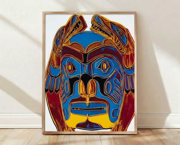 Pop art framed poster of a Northwest Coast indigenous mask in vibrant reds, yellows, and blues against a contrasting background, characteristic of 1980s Warhol-style silkscreen printing.