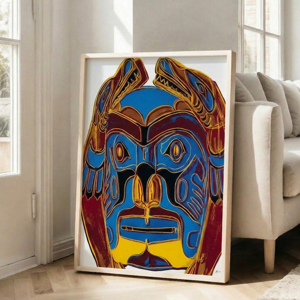 Framed wall art displaying a Northwest Coast tribal mask in striking neon-bright hues, executed in the distinctive flat, bold graphic style of 1980s Pop art.