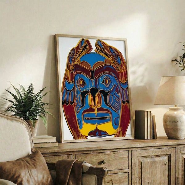 Pop art wall poster of a Northwest Coast indigenous mask with intense, contrasting color combinations and simplified forms typical of Warhol's Cowboys and Indians collection.