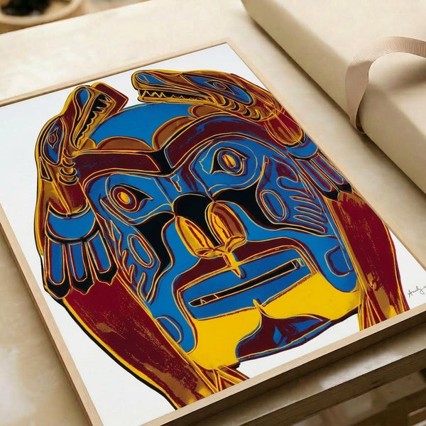 Vibrant framed poster featuring a Northwest Coast mask rendered in multiple bright color combinations with the iconic flat, high-contrast aesthetic of Pop art printmaking.