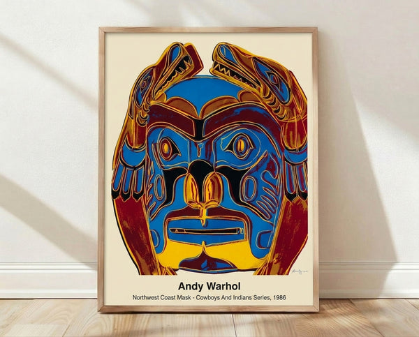 Bold pop art interpretation of a Northwest Coast mask in vibrant red, yellow, turquoise, and black, framed on a wall as a modern art print.