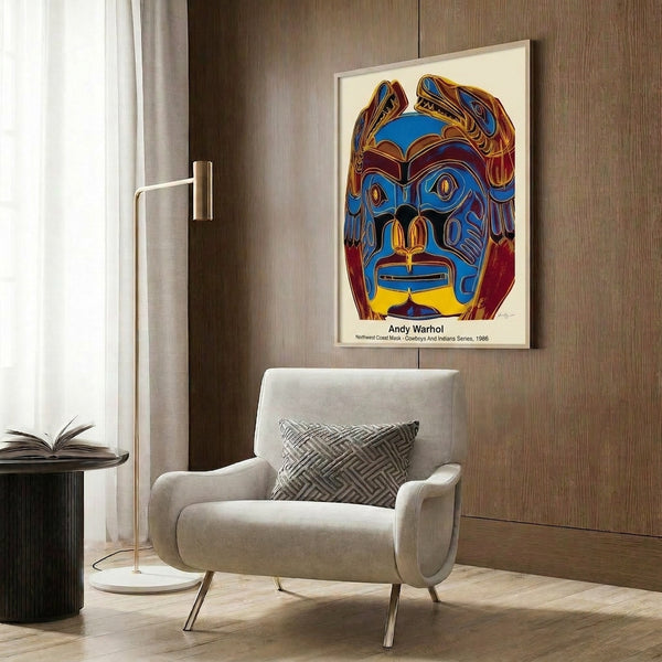 Vibrant pop art mask print on a wall featuring bold geometric forms in striking reds, oranges, yellows, and turquoise tones.