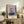 Introspective abstract poster showing a figure and mirror composition in muted earth tones and blacks, with a visceral, emotionally charged aesthetic.