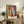 Modern art print of a contemplative woman and her mirrored reflection in an interior setting, featuring sensual curves in coral, ochre, cream, and deep blue tones.