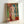 Stylized portrait of an odalisque in contemplative pose, combining curved organic forms with a harmonious blend of ochres, reds, and muted jewel tones.