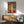 Matisse-style artistic composition of a seated odalisque in profile, blending fluid line drawing with warm saturated colors and decorative patterning.