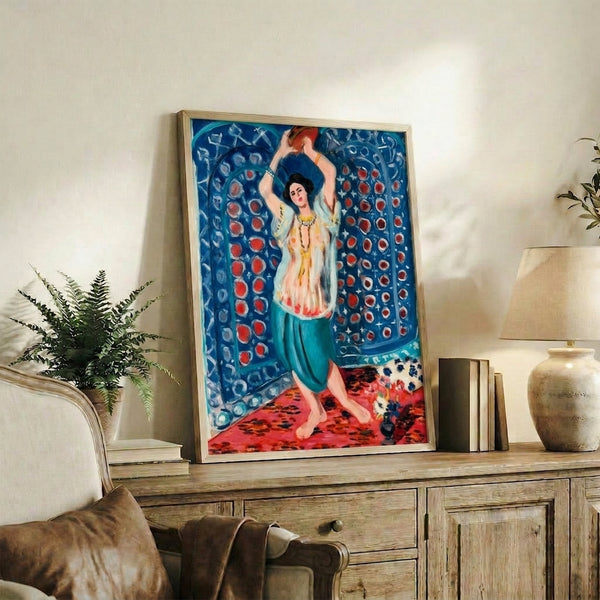 Poster print featuring an odalisque holding a tambourine amid flowing fabrics, rendered in soft pinks, warm ochres, and blue tones with artistic, meditative quality.