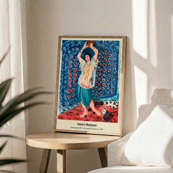 Framed vintage-style artwork depicting a woman with tambourine in Art Nouveau-inspired Impressionist palette of ochre, cream, rose, and deep blue.