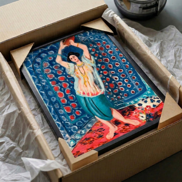 Art print on wall showing contemplative odalisque figure with tambourine, sensual composition in warm ochres and soft pinks contrasting with blue fabric in Impressionist style.