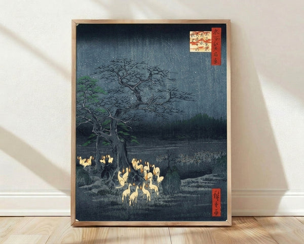 Japanese woodblock print featuring foxes with glowing fire amid a serene forest and starlit night sky in deep teals, blacks, and pale yellow tones.