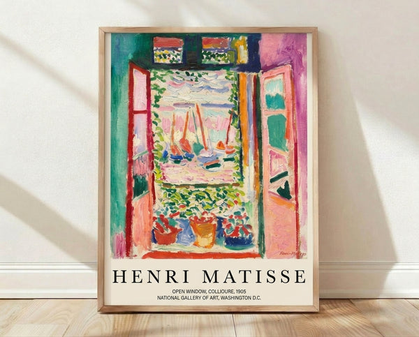 Vibrant Matisse-inspired framed poster depicting an open window overlooking a seascape with sailboat, potted plants, and flowers in emerald green, coral pink, ocean blue, and golden yellow.
