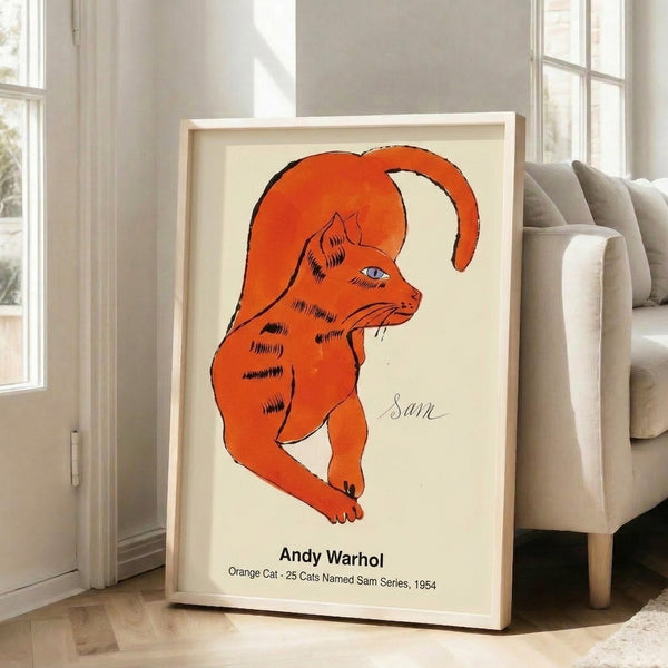 Framed art print of an orange cat in vibrant pop art style, combining playful imagery with iconic modern art techniques and striking color contrast.