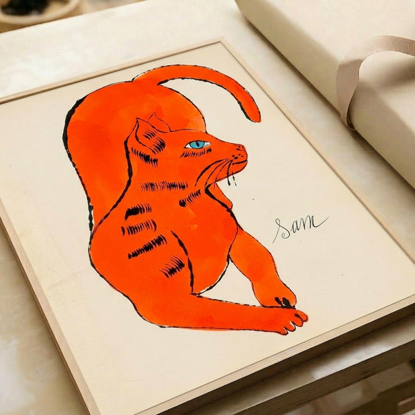 Pop art style cat portrait in vivid orange tones with high-contrast graphic design, mounted as a framed print for wall decoration.