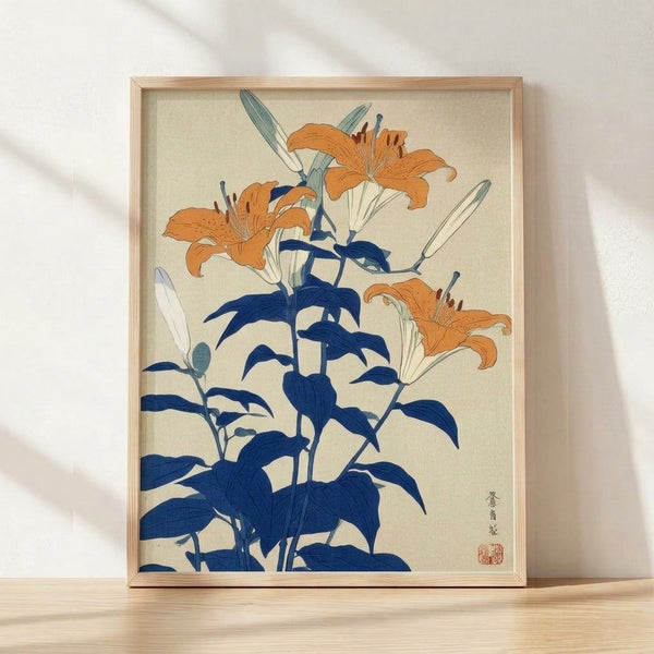 Framed Japanese woodblock print of orange and cream tiger lilies with sage green leaves and stems on navy blue background, serene botanical artwork in minimalist Japandi style.