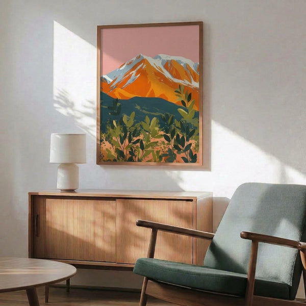 Modern nature-inspired wall art depicting serene mountain landscape with snow-capped peaks in white and warm sunset hues of pink and orange against deep teal sky.